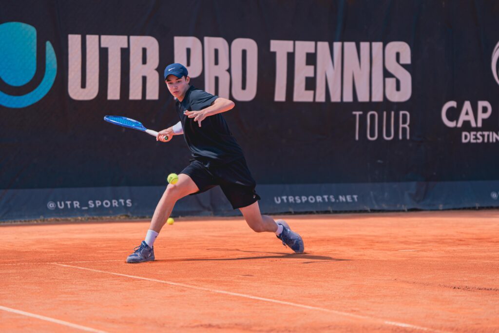 A player hitting a forehand on clay during the Tennis Showcase 2026.