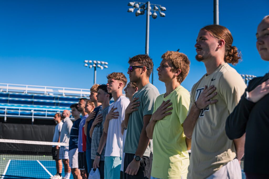 Young players lined up on a tennis court at the USTA National Campus in Florida