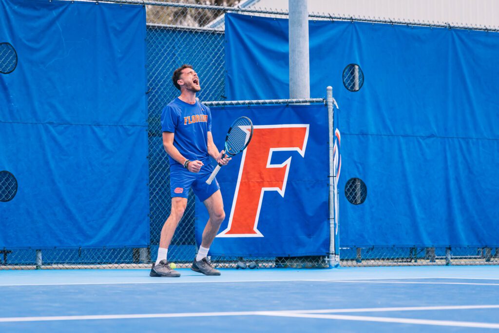 Tennis player on the Florida Gators courts celebrating a point